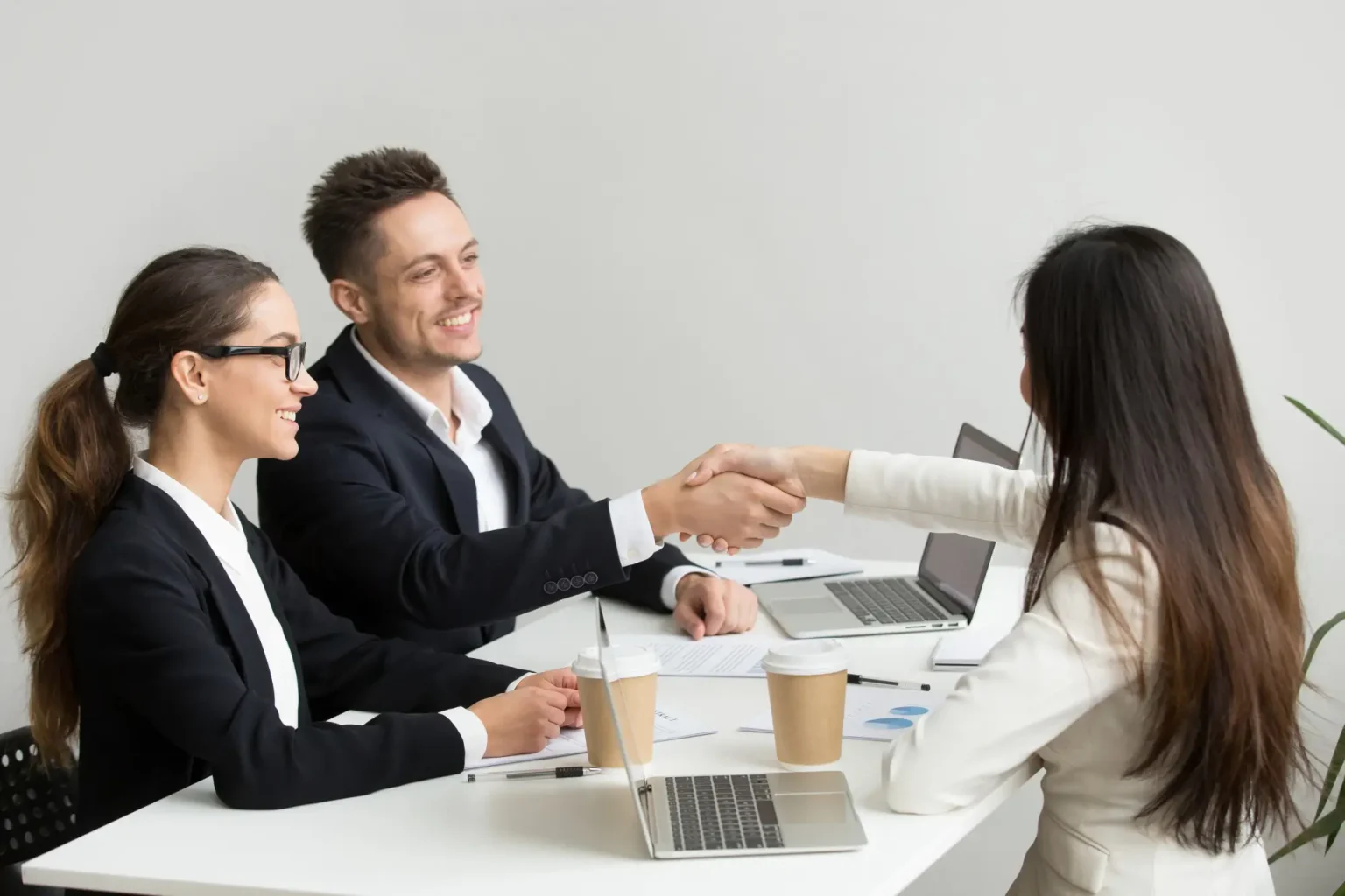 friendly-partners-handshaking-group-meeting-thanking-successful-teamwork-1536x1024